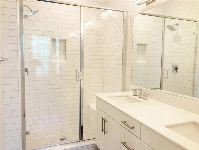 a bathroom with a shower and a sink