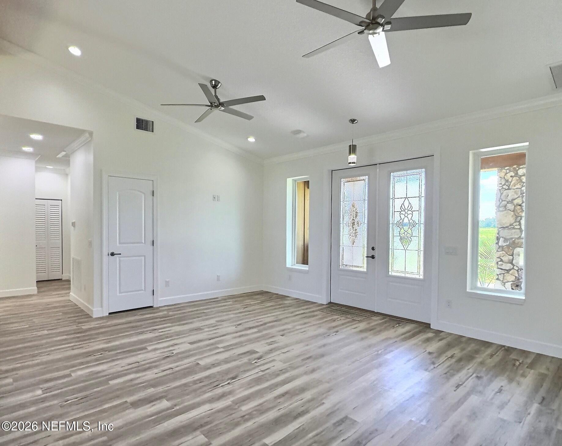 159 Mays Cove Road East Palatka, FL 32131 - Photo 10 of 62 a view of an empty room with a window and wooden floor