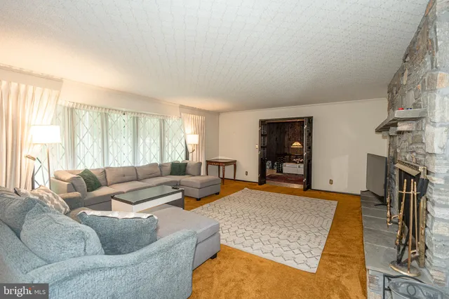 a bedroom with a bed mirror and window