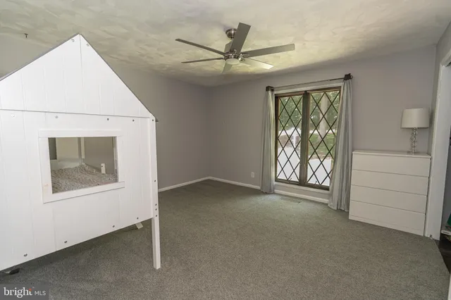 a bedroom with bed and white walls