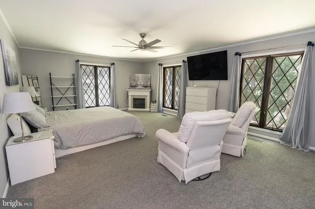 a spacious bathroom with a granite countertop sink a toilet a mirror and a window