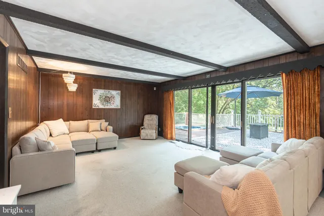 a kitchen with stainless steel appliances granite countertop a refrigerator a sink dishwasher a stove and white countertops with wooden floor