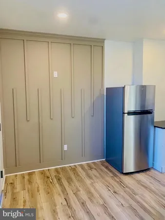 a view of a refrigerator in kitchen and wooden floor