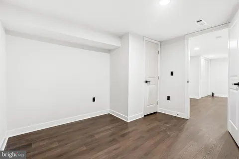 a view of a room with wooden floor