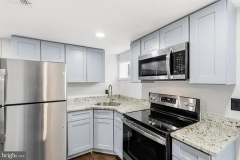 a kitchen with a sink stove and refrigerator