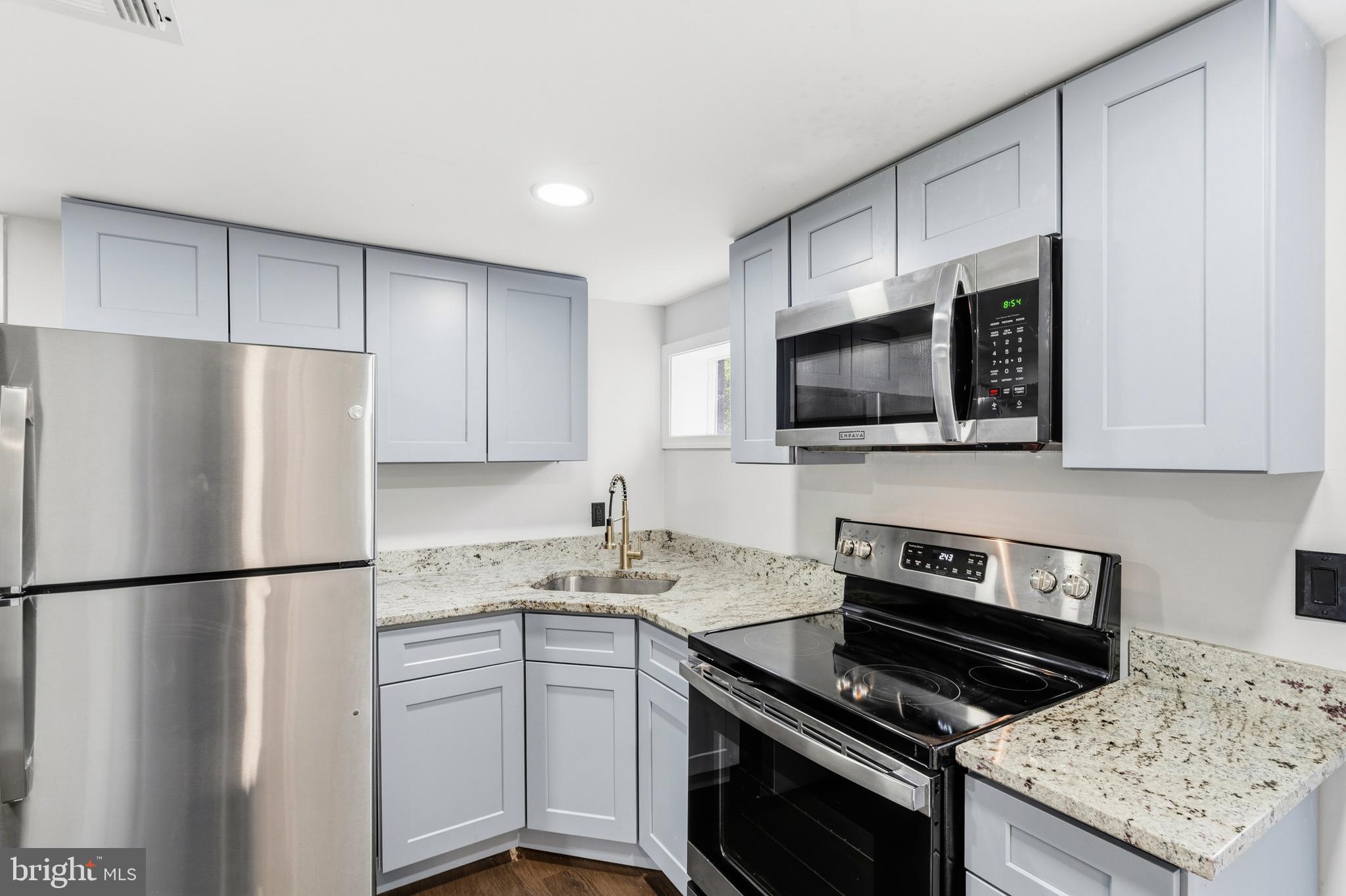 9529 Temple Hill Road Clinton, MD 20735 - Photo 13 of 14 a kitchen with a sink stove and refrigerator