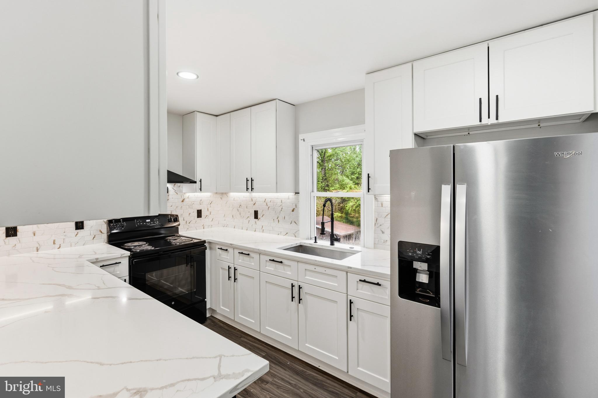 9529 Temple Hill Road Clinton, MD 20735 - Photo 4 of 14 a kitchen with stainless steel appliances a refrigerator sink and cabinets