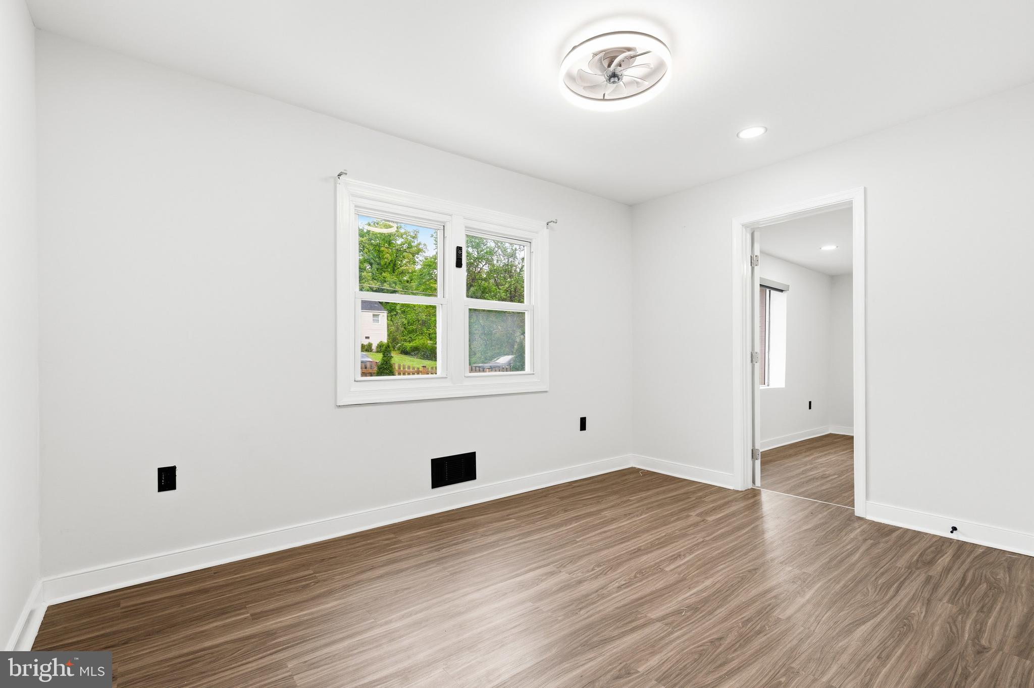9529 Temple Hill Road Clinton, MD 20735 - Photo 7 of 14 an empty room with wooden floor and windows