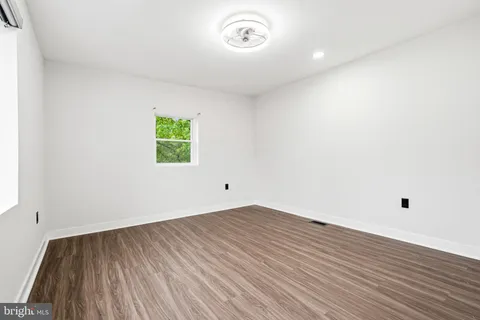 a view of room with window and wooden floor