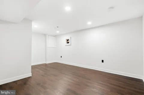 an empty room with wooden floor