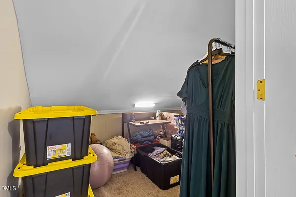 a view of a bedroom with mirror and fan