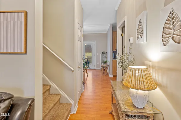 a hallway with wooden floor and furniture