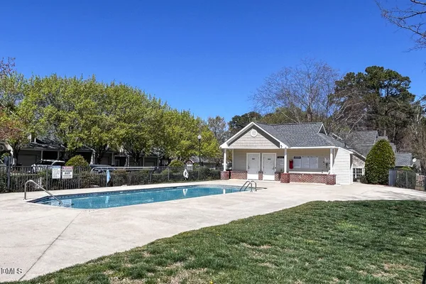 a swimming pool view with a outdoor seating
