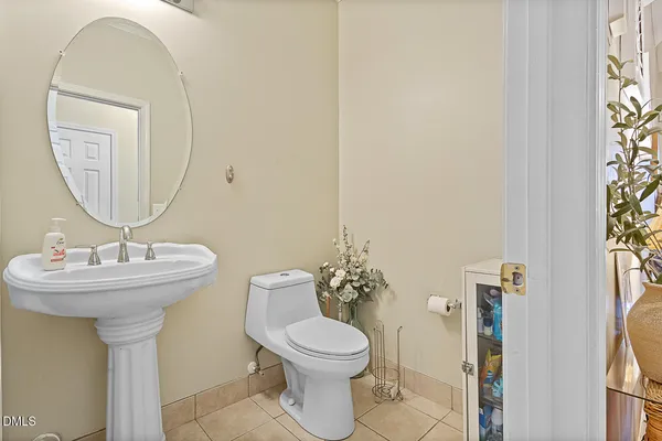 a bathroom with a toilet a sink and a mirror