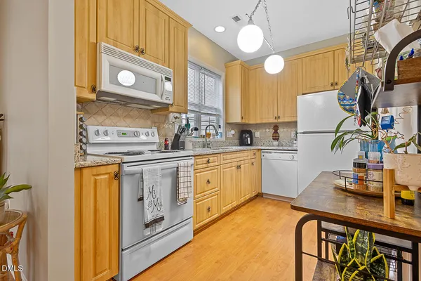 a kitchen with cabinets a sink and appliances