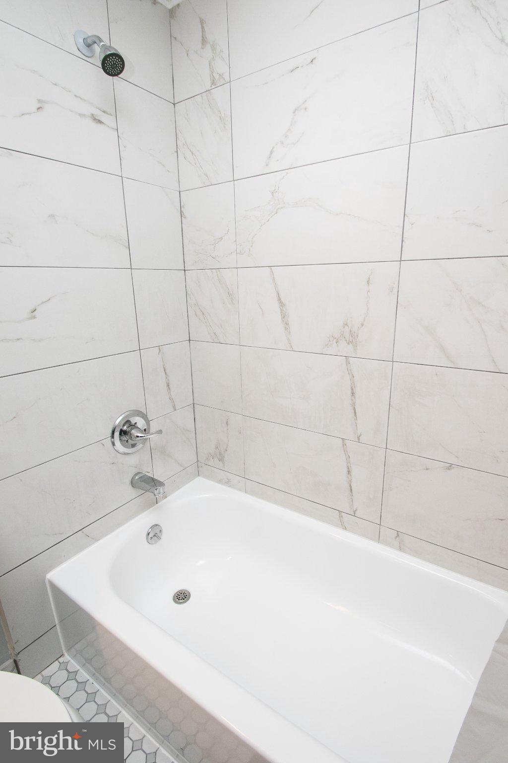 2135 Walnut Street, Unit 304 Philadelphia, PA 19103 - Photo 7 of 8 Sleek marble bath retreat awaits you.