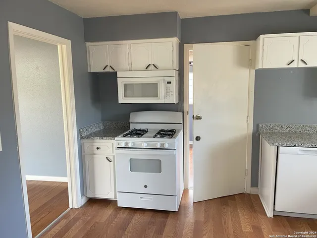 a kitchen with a stove microwave and refrigerator