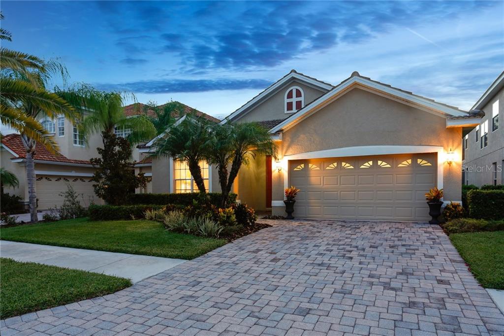 18040 Java Isle Drive Tampa, FL 33647 - Photo 1 of 1 a front view of a house with a yard and garage