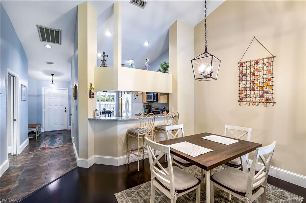 1350 Misty Pines Circle, Unit 204 Naples, FL 34105 - Photo 11 of 19 a kitchen with a table chairs and refrigerator
