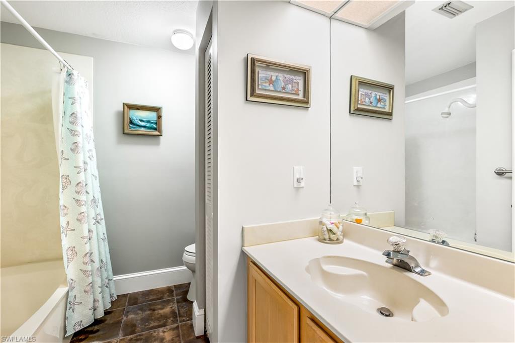 1350 Misty Pines Circle, Unit 204 Naples, FL 34105 - Photo 15 of 19 a bathroom with a sink and a mirror