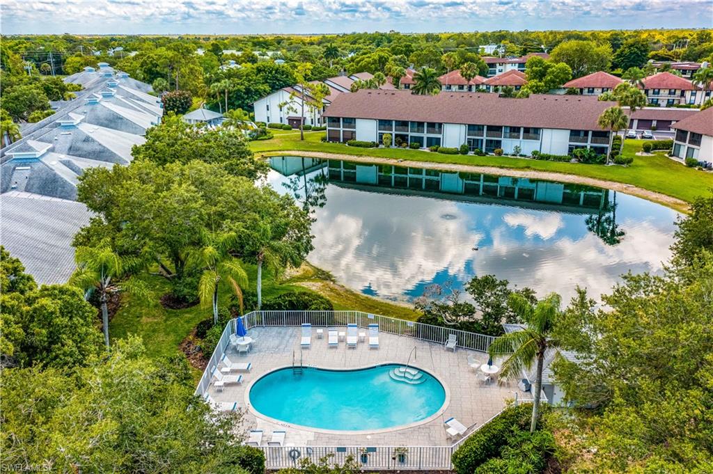 1350 Misty Pines Circle, Unit 204 Naples, FL 34105 - Photo 18 of 19 an aerial view of a house with a garden and lake view