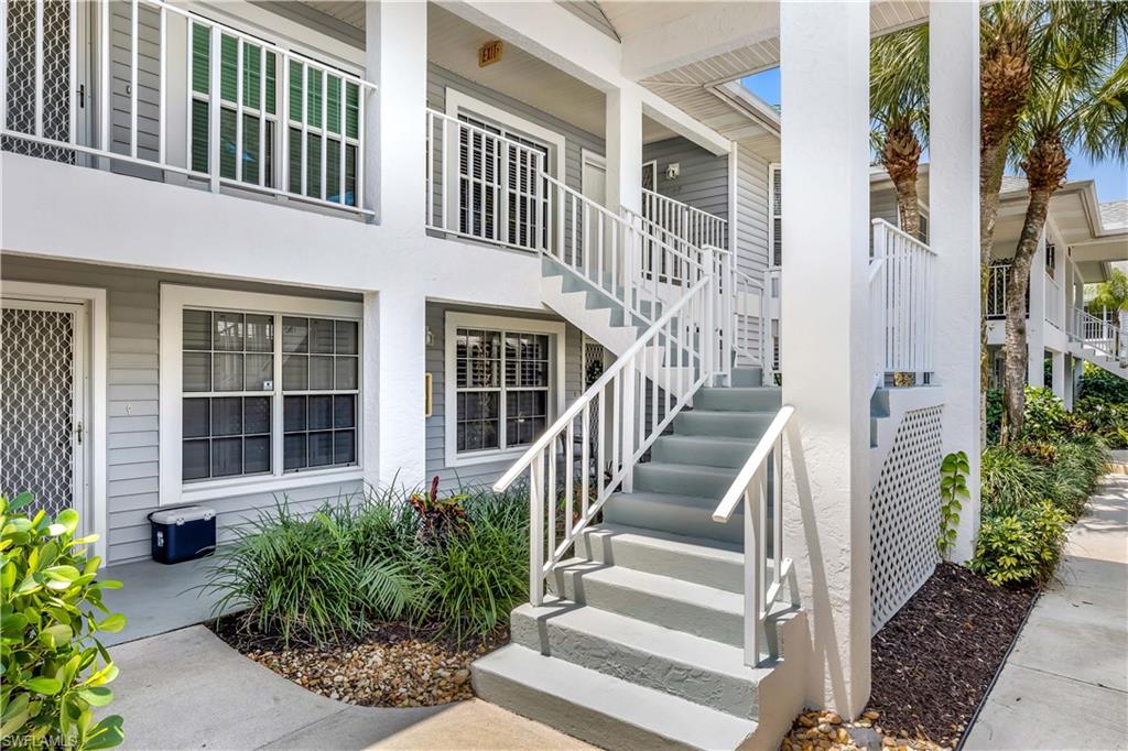 1350 Misty Pines Circle, Unit 204 Naples, FL 34105 - Photo 3 of 19 a view of a brick house many front of plants