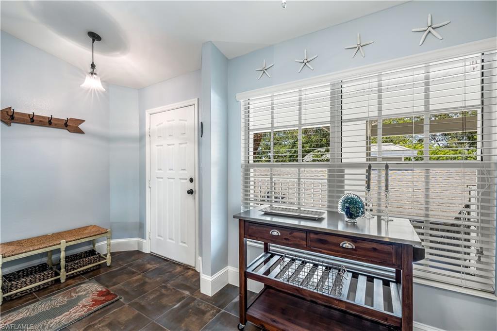 1350 Misty Pines Circle, Unit 204 Naples, FL 34105 - Photo 4 of 19 a view of a room with furniture and a window