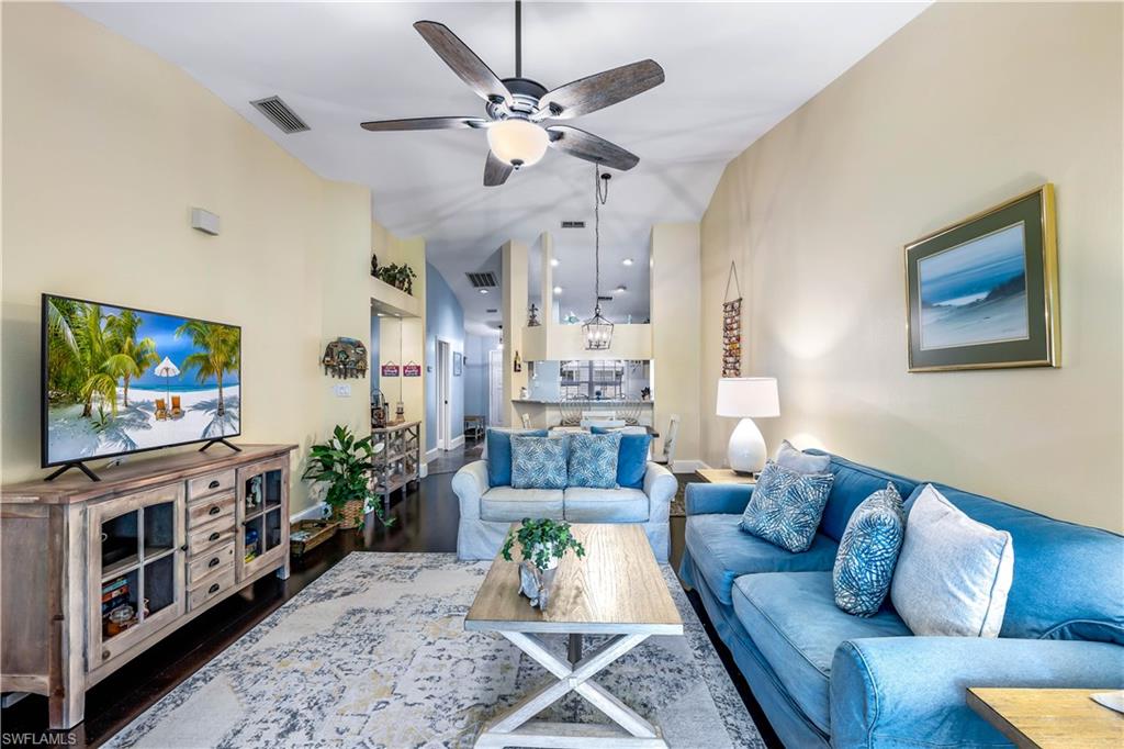 1350 Misty Pines Circle, Unit 204 Naples, FL 34105 - Photo 5 of 19 a living room with furniture and a flat screen tv