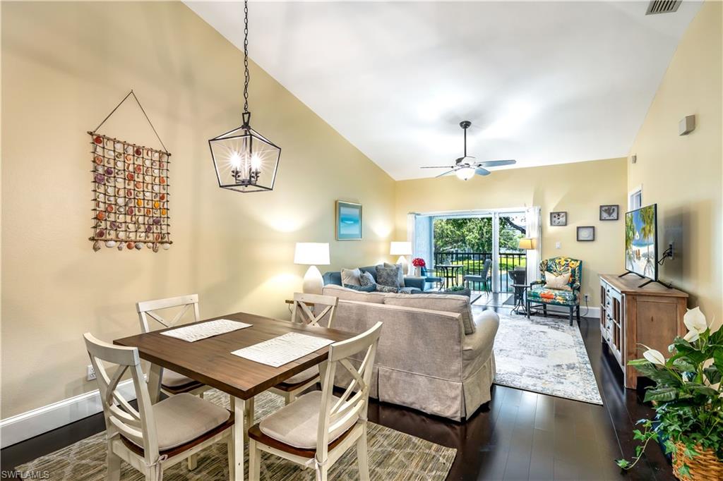 1350 Misty Pines Circle, Unit 204 Naples, FL 34105 - Photo 9 of 19 a view of a dining room with furniture window and wooden floor