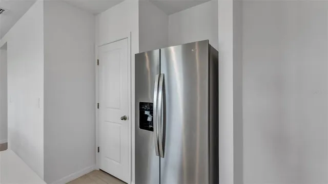 a kitchen with refrigerator cabinets dining table and chairs