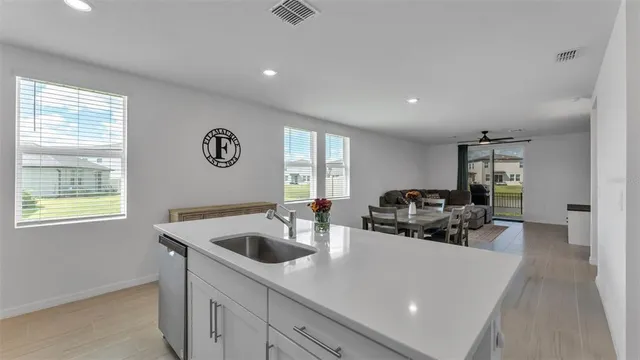 a living room with furniture and a ceiling fan
