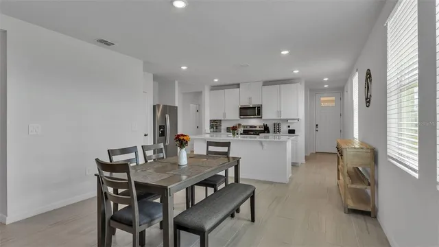 a living room with furniture and kitchen view
