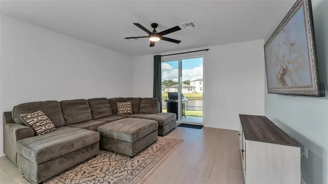 a spacious bedroom with a bed and a ceiling fan