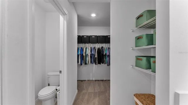 a bedroom with a bed and a lamp on dresser