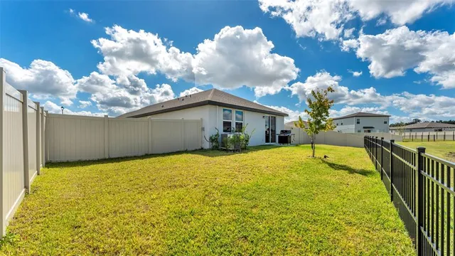 a view of house with garage and yard