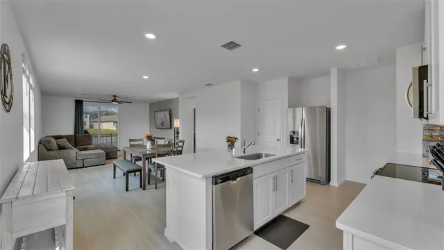 a living room with furniture kitchen view and a fireplace