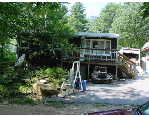 4 Old Mashapaug Road Holland, MA 01521 - Photo 1 of 4 a view of a house with backyard stove and sitting area