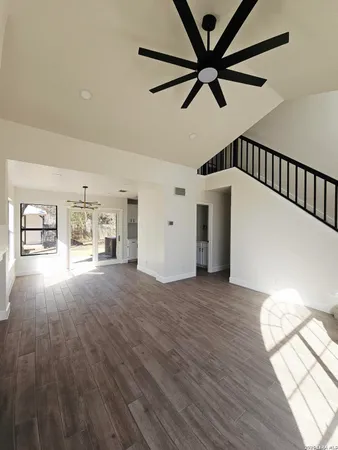 a view of empty room with a window and wooden floor