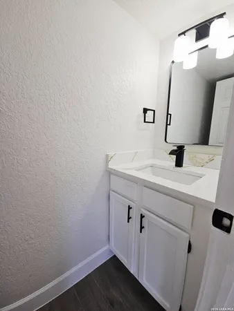 a bathroom with a sink and a mirror