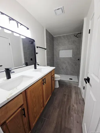 a bathroom with a double vanity sink and mirror