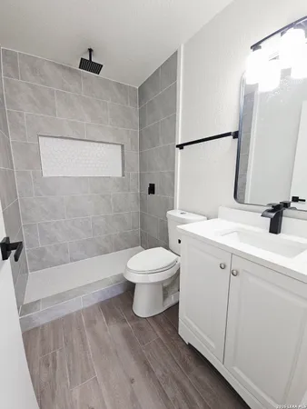 a bathroom with a sink toilet and shower