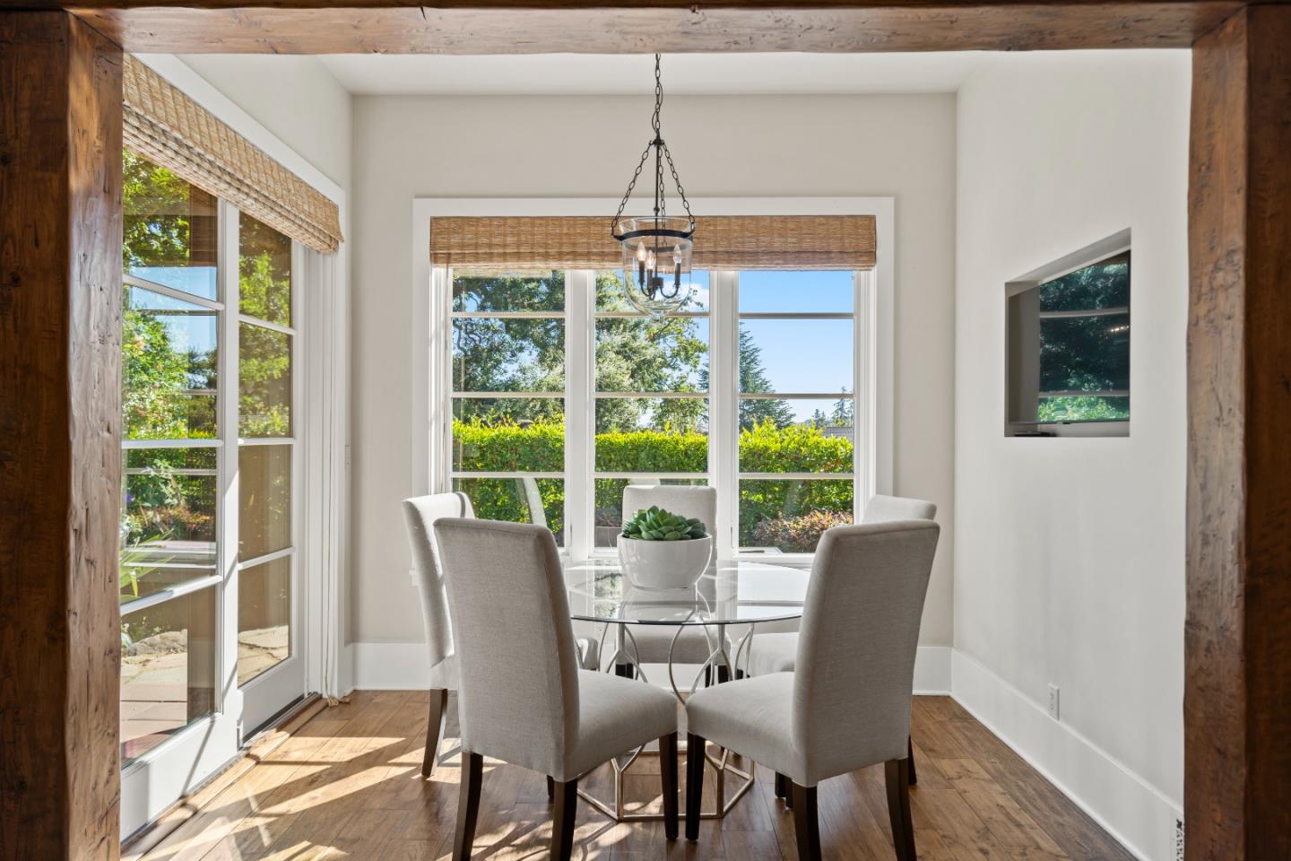 1056 Cascade Drive Menlo Park, CA 94025 - Photo 13 of 32 a dining room with wooden floor a chandelier and windows