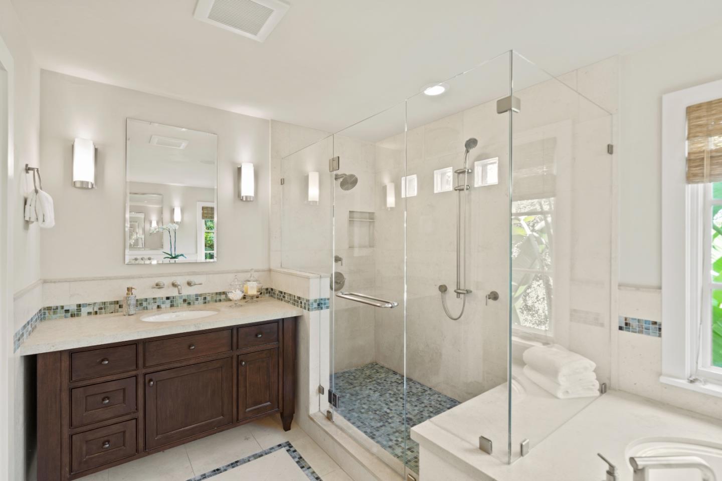 1056 Cascade Drive Menlo Park, CA 94025 - Photo 17 of 32 a spacious bathroom with a granite countertop sink mirror and shower