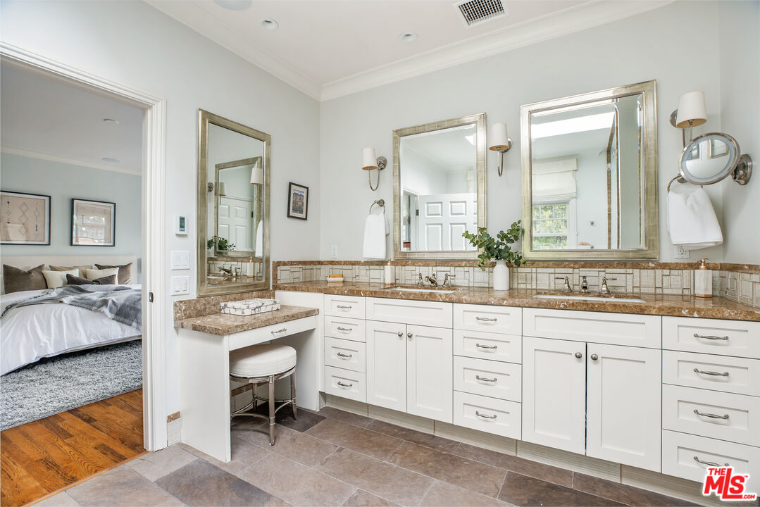 342 10th Street Santa Monica, CA 90402 - Photo 33 of 53 a spacious bathroom with a granite countertop sink and a mirror