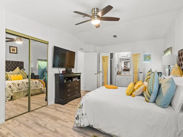 a bedroom with a bed and wooden floor