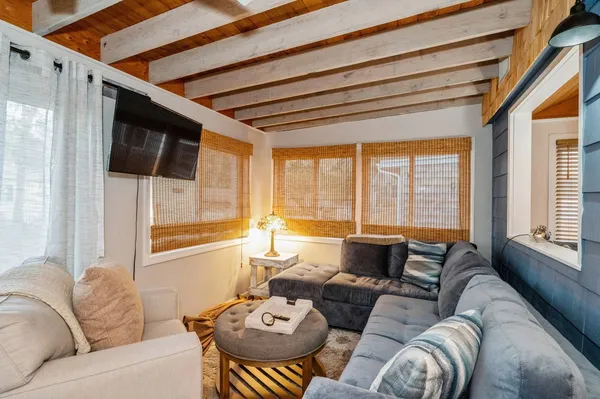 a living room with furniture and large windows