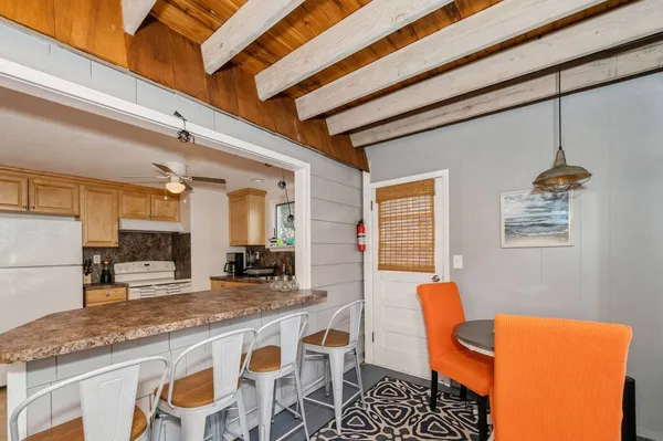 a dining table with chairs and cabinets