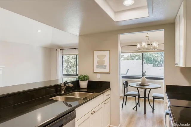 a kitchen with a sink and chairs