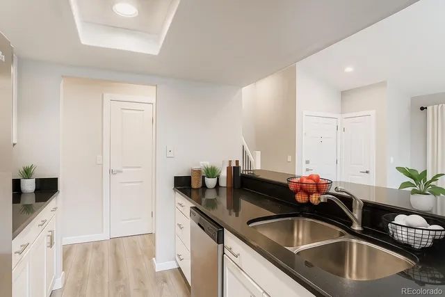 a kitchen with granite countertop a sink and cabinets