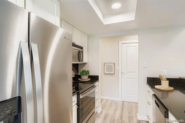 a kitchen with stainless steel appliances a refrigerator sink and stove